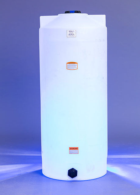 A large, cylindrical white plastic water tank stands upright against a blue background. The tank has a lid on top and warning labels on its surface.