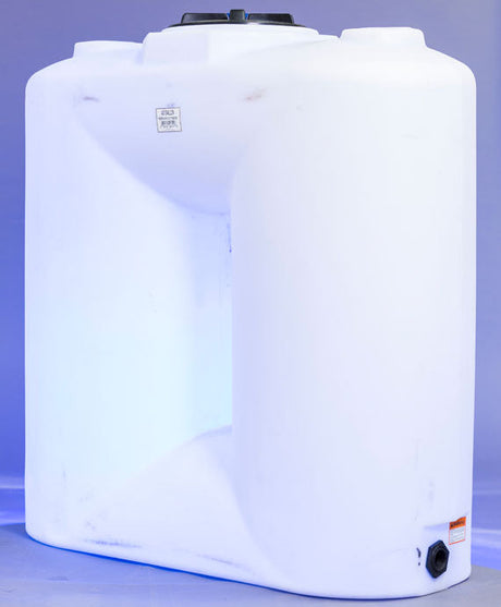 A large white rectangular plastic tank with a black cap on top and a small outlet at the bottom. The background is a gradient of light and darker blue.