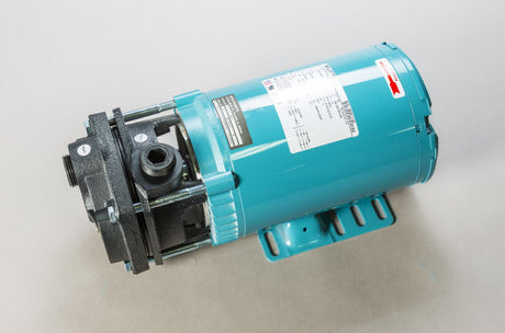 A teal-colored motor or pump with a black mounting bracket, shown on a neutral background. Various labels and controls are visible on its surface.